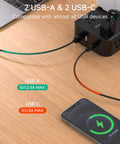 12 In 1 Power Strip With USB C And USB A Ports 8 Outlets 4 USB Ports Flat Plug Wall Mount Surge Protector For Home Office Desk Setup Ready To Rock Your Space With Overload Safety, shown charging phone and laptop