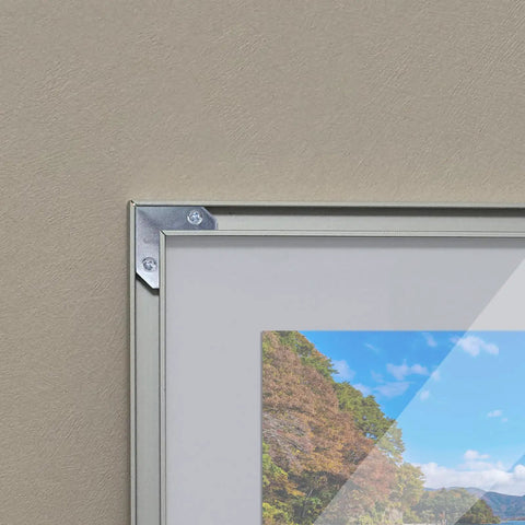 Rock Solid L Shaped Corner Brace Brackets 30 Pack 35x13mm used to secure a picture frame corner with visible screws.