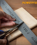 Pro Grade Emery Cloth Sandpaper Roll 120 Grit 1.5 In X 10 Yards Aluminum Oxide Abrasive being cut for metal and woodworking.