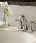 Eva Brushed Nickel Two-Handle 4-Inch Centerset Bathroom Faucet With Drain Assembly in a 3-Hole Sink, against tiled wall