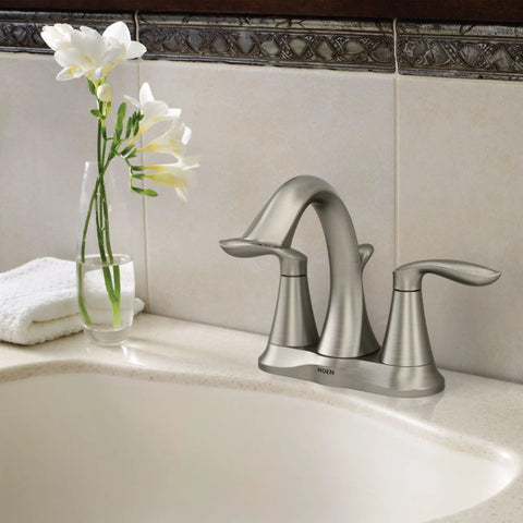 Eva Brushed Nickel Two-Handle 4-Inch Centerset Bathroom Faucet With Drain Assembly in a 3-Hole Sink, against tiled wall