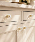Six Pack Swanky Clear Faceted Glass Cabinet Knobs With Trendy Gold Alloy Base on a stylish dresser with a beige finish.