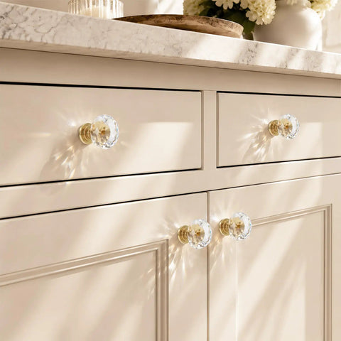 Six Pack Swanky Clear Faceted Glass Cabinet Knobs With Trendy Gold Alloy Base on a stylish dresser with a beige finish.