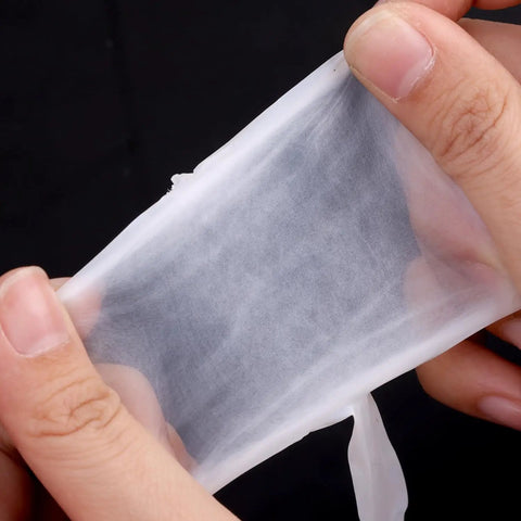Hands stretching a piece of Six Pack PTFE Plumbing Tape Sealant For Quick Leak Stops At Pipe Fittings And Sink Drains Waterproof Thread Sealant Tape For Do It Yourself Repairs Pro Grade Leak Prevention For Home And Industrial Use