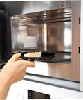 Hand placing dish in microwave with 30 Pcs Oven Mica Plates And Microwave Mica Sheets Heat Insulation Covers For Microwave installed.