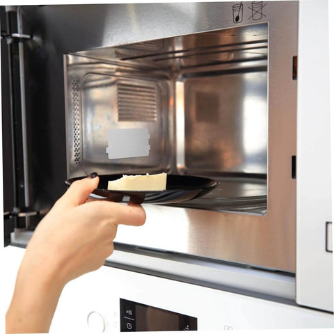 Hand placing dish in microwave with 30 Pcs Oven Mica Plates And Microwave Mica Sheets Heat Insulation Covers For Microwave installed.