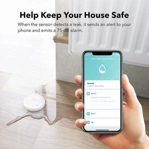 Smart Water Leak Detector 2 Pack With WiFi Alerts And 75 DB Alarm placed on floor near leak with smartphone app open