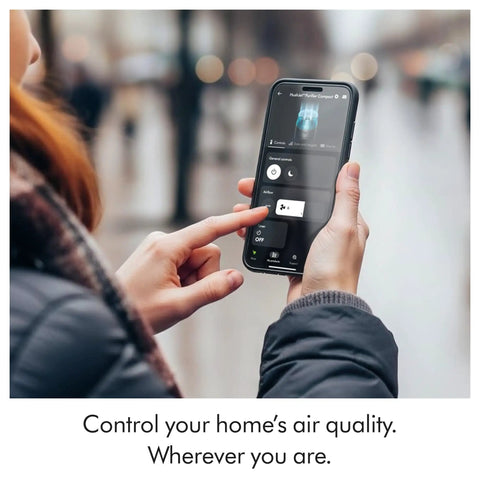 Person using smartphone to control Whisper Quiet Compact Air Purifier For Whole Room Coverage Pet And Allergy Friendly Fully Sealed
