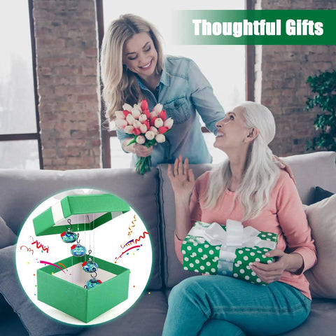 Two women exchanging gifts with an inset showing Outdoor Wind Chimes And Hummingbird Feeder Duo For Your Garden Vibes package.