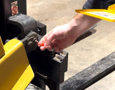 Hand installing a yellow grease fitting cap on machinery, Grease Fitting Caps 50 Count Yellow Must Have For Any Mechanic Fits All Standard SAE And Metric Fittings With Integrated Collar That Keeps Cap Attached For Quick Maintenance And Keeps Dirt Out And Prolongs Fitting Life displayed prominently.