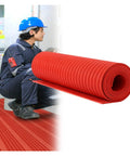 Heavy Duty Insulated Rubber Floor Mat Non Conductive Workspace Essential With Top Notch Non Slip Grip To Keep Ya Safe From Electric Shock Hazard Industrial Grade Power Tile Rock Solid rolled next to a worker wearing a blue hard hat.