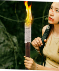 Person holding an Outdoor Wood Torch Lantern For Garden And Patio Decor, Flickering Flame Light For Walkways And Yards.