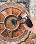 Close-up of a person using a 30 Piece 2 Inch Mini Flap Disc with 1 Quarter Inch Shank Holder on a rusted metal surface.