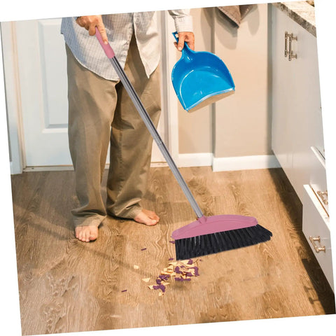 Legit Heavy Duty Pink Broom With Sturdy Steel Handle And Ultra Soft Bristles For Zero Sweat Indoor And Outdoor Floor Cleanup Compact Reusable Dust Brush That Really Cleans in use sweeping up debris on wood floor.