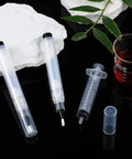 Five Pack Touch Up Paint Pens For Walls Fillable And Refillable Reusable Wall Repair Tools with syringe and cap on black surface