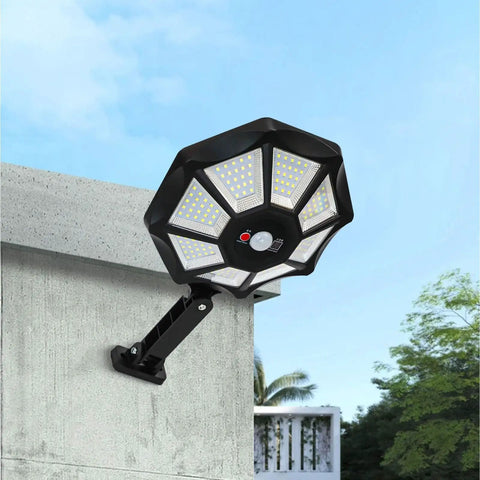 Solar Flood Light 168LED Motion Sensor IP66(168LED) mounted on a wall with bright LED design against a clear blue sky.