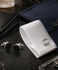 Two Pair Silver Plated French Cufflinks For Men Highlighting Smooth Black Enamel Disks on white cuff shirt.