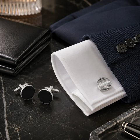 Two Pair Silver Plated French Cufflinks For Men Highlighting Smooth Black Enamel Disks on white cuff shirt.