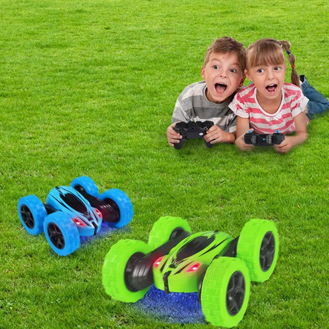 Kids playing with Two Pack RC Stunt Cars for Kids Fast 2.4GHz Remote Control Off Road Rock Crawler 4WD on grass