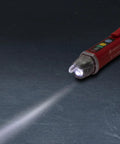 Heavy Duty Non Contact Ac Voltage Detector With Dead Nuts Accurate Dual Ranges And Instant Audible Visual Alerts Featuring A Bright Flashlight Plus Cat Iv Safety Rating For Pro Wiring Jobs Needing Reliable Power Checks Every Time on a dark surface with flashlight beam