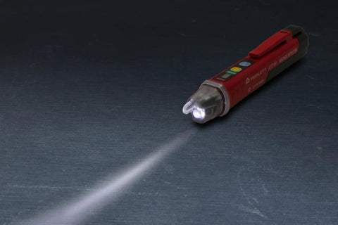 Heavy Duty Non Contact Ac Voltage Detector With Dead Nuts Accurate Dual Ranges And Instant Audible Visual Alerts Featuring A Bright Flashlight Plus Cat Iv Safety Rating For Pro Wiring Jobs Needing Reliable Power Checks Every Time on a dark surface with flashlight beam