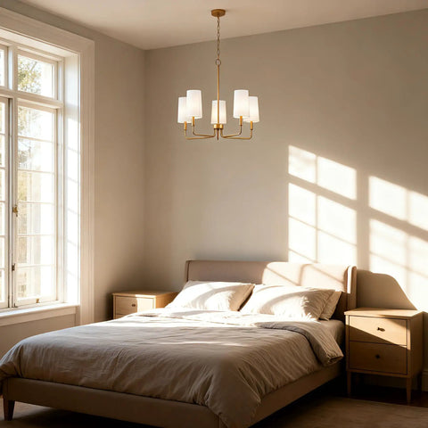 Muted Gold Chandelier With White Fabric Shades For Modern Farmhouse Linear Island Lighting In Kitchen And Dining Room, 5-Light Fixture, 60 Inch Chain, Cozy Warm Glow Vibe over bed in sunlit bedroom.
