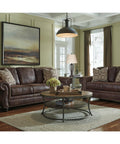 Living room with brown sofas, coffee table, and two pack table lamps with open concept oil rubbed bronze metal bases and fabric hardback shades.