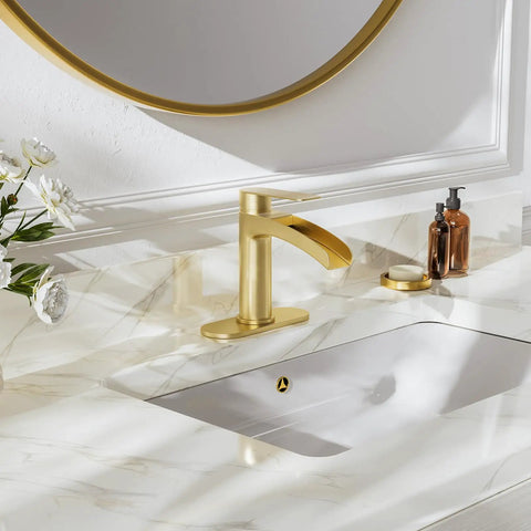 Single Handle Waterfall Bathroom Faucet in Brushed Gold with 6 Inch Deck Plate and Metal Pop Up Drain on marble vanity