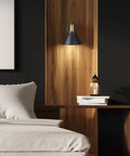 Adjustable Swing Arm Wall Sconce With Plug In Cord And On Off Switch Industrial Bronze Black Finish in a modern bedroom setting
