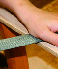 Heavy Duty Three Piece Wood Rasp File Set With Eight Inch Round Half Round And Flat Steel Files Featuring Soft Rubber Grip Handles For Pro Carpenters Knocking Down Rough Surfaces And Smoothing Hardwood Like A Champ, hand using file on wood surface.