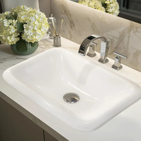 22 Inch By 15 Inch Drop In Ceramic Bathroom Sink White Rectangle Vessel Style With Overflow No Fuss Easy Clean Semi Recessed Mount Vitreous China Smooth Glazed Finish installed on marble countertop with flowers