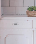 White cabinet with a missing handle next to a pot of succulents on a tiled countertop, suitable for 2 Pack Zinc Alloy Cabinet Handles For Drawers And Wardrobes, Metal Dresser Pulls, Wardrobe Door Handles, Furniture Drawer Pulls, Built To Last And Slick Cabinet Hardware For Any Home Makeover.