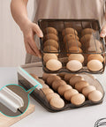 Person using 36 Grid Capacity Automatic Rolling Egg Holder For Refrigerator Two Layer Stackable Egg Tray Organizer Fridge Egg Storage Rack With No Fuss Auto Roll Design Food Grade PP Light Brown in a kitchen