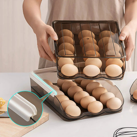 Person using 36 Grid Capacity Automatic Rolling Egg Holder For Refrigerator Two Layer Stackable Egg Tray Organizer Fridge Egg Storage Rack With No Fuss Auto Roll Design Food Grade PP Light Brown in a kitchen