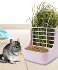 Super Cool Pink Two In One Rabbit Hay Feeder With Automatic Guinea Pig Food Bowl And Quick Release Grass Rack with hay and a chinchilla.