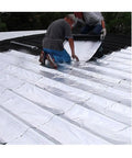 Two men applying No Fuss Tough As Nails Self Adhesive Ice And Water Shield Roof Flashing Tape on a roof.