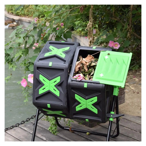 Outdoor 140L Dual Chamber Rotary Compost Bin in garden setting showing durable plastic steel construction with green and black design.
