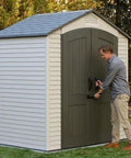 Man securing Built Tough Outdoor Storage Shed 7 x 4.5 Ft with steel reinforced construction and double wall HDPE in backyard