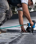 Worker using Heavy-Duty 15 Degree Roofing Nailer With Coil Magazine, Shoots Nails From 3/4 To 1-3/4 Inches, Low Recoil Pneumatic Nail Gun Built Tough For Roofer Job Sites on a roof.