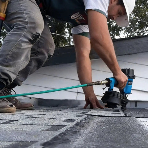 Worker using Heavy-Duty 15 Degree Roofing Nailer With Coil Magazine, Shoots Nails From 3/4 To 1-3/4 Inches, Low Recoil Pneumatic Nail Gun Built Tough For Roofer Job Sites on a roof.