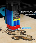 TTS-55 Pro Laser Engraver 5.5W DIY Laser Cutter With Air Assist engraving wood with an intricate design, shown close-up.