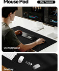 Man using Leather Office Desk Pad Protector, Large Non Slip PU Leather Mouse Pad And Writing Desk Blotter in black on desk