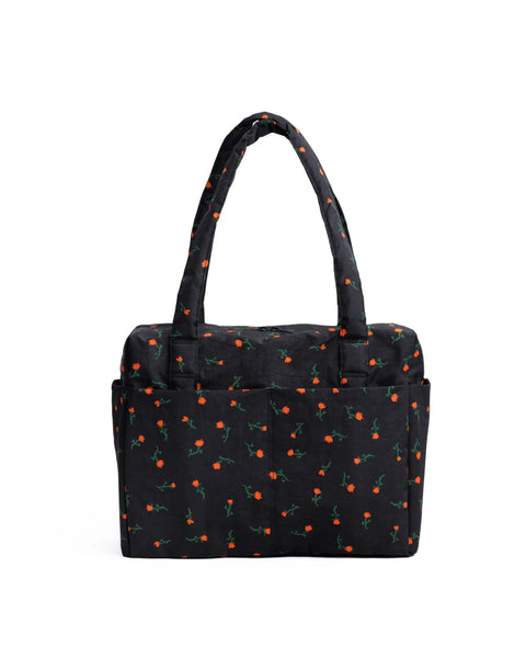 Underseat Travel Carry On Bag Built With Recycled Nylon Small Cloud Style Painted Wildflower Fits Under Airplane Seat And On Top Of Rollers Exterior Pockets For Quick Access Washable And Lightweight - Black bag with red wildflower pattern, exterior pockets, and shoulder straps