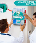 Two people mounting a 420 Piece Pro First Aid Kit In A Sturdy Hard Case with medical supplies on a wall.