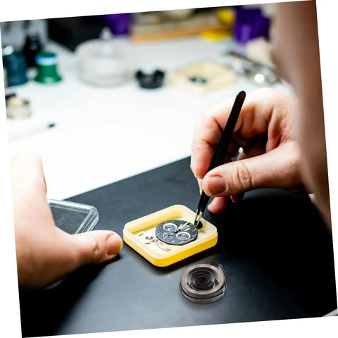 Person using tweezers to repair watch in Complete Mechanical Alarm Clock Repair Kit With Spring Steel Return Spring Assembly And Parts