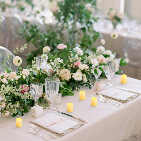 Elegant wedding table decorated with Flameless LED Votive Candles 24 Pack 1.5x2 Inches Battery Operated Tea Lights for cozy ambiance