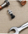 Close-up of Stainless Steel Spring Indexing Plunger with Fast Reset Mechanism, surrounded by tools, ideal for heavy machinery use.