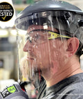 Premium Lightweight Frameless Safety Glasses with Killer Antifog Lens and Rock Solid Comfort for Marathon Shifts Bulk Box Includes 144 Pairs Green Gray Wraparound Shield Protection for Construction Crews worn by a worker in a shop.