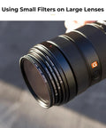 Close-up of 9 Piece Step Up Ring Set And 9 Piece Step Down Ring Set Camera Lens Filter Adapter Kit attached to a camera lens.