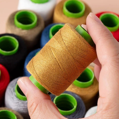 Close-up of a spool from Ten Color Sewing Thread Kit With Heavy Duty Denim Grade Polyester Spools 20s/3 Thick Thread Includes Needles Needle Threader And Thimble 200 Yards Per Roll Perfect All In One For Jeans And Garment Repairs